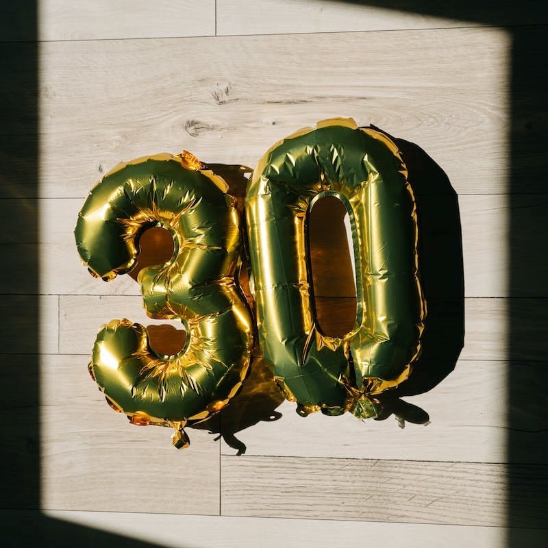 number three and zero gold colored balloons