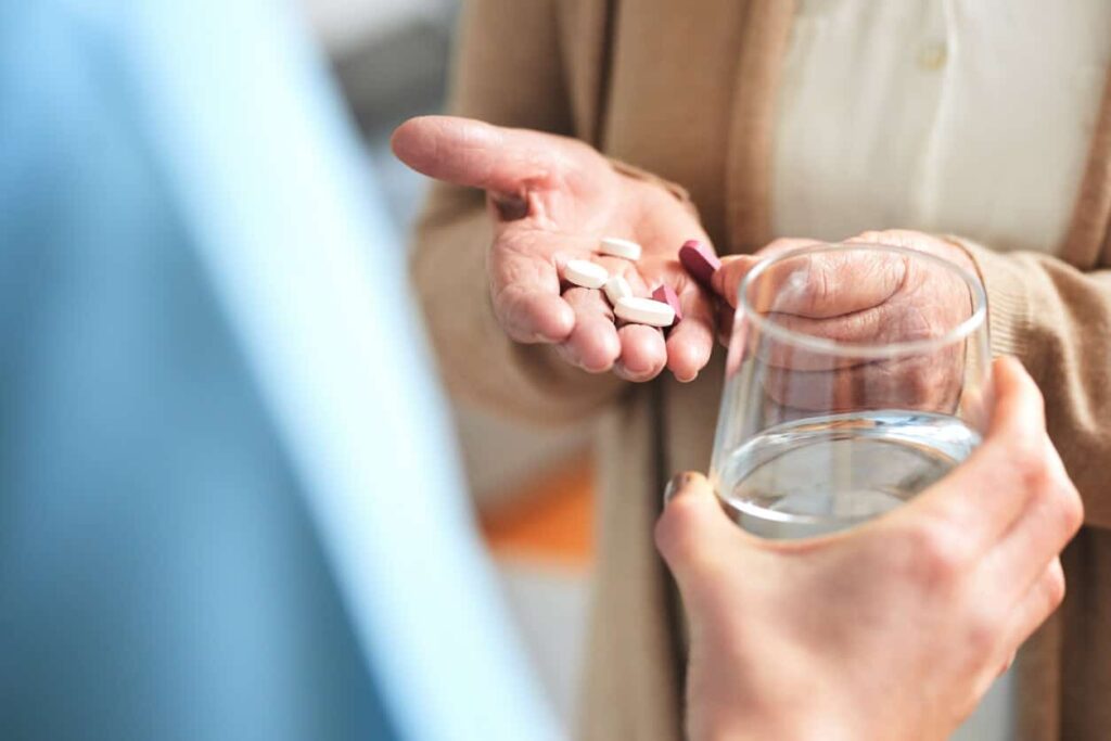 person holding pills in hands