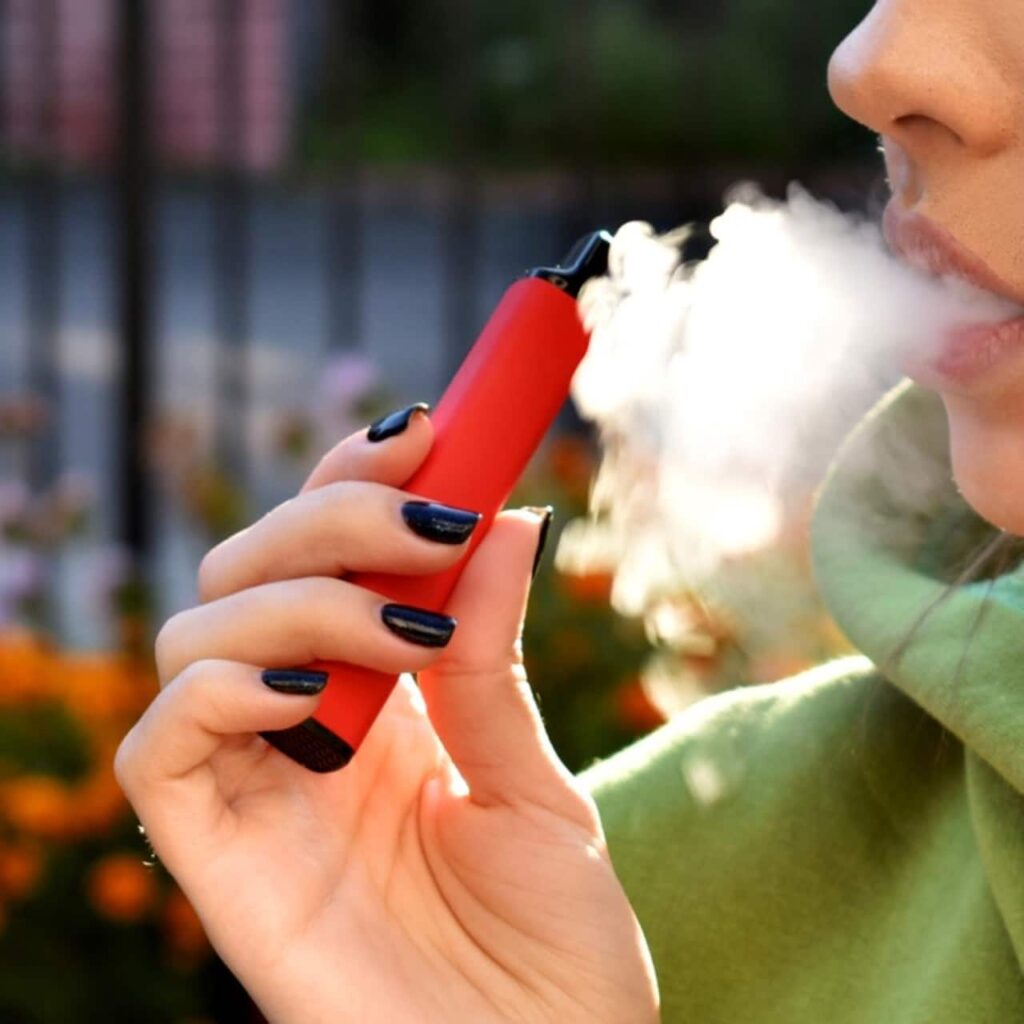 woman smoking electronic cigarette in a public place