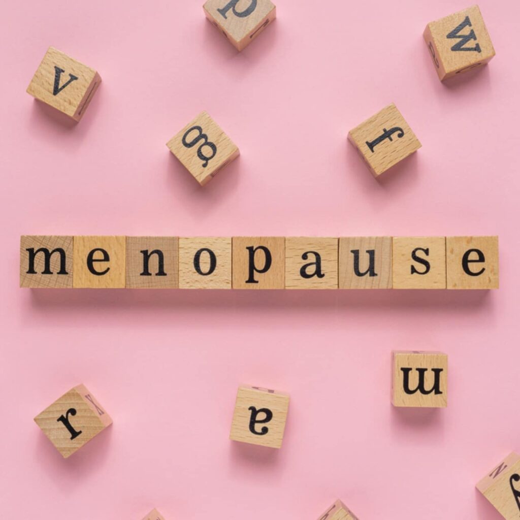 Menopause word on wooden block.